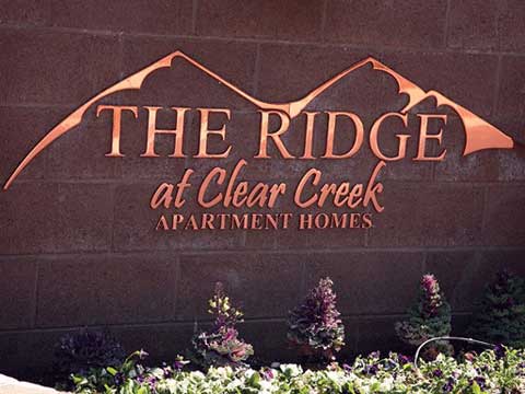 Polished copper letters at the Ridge at clear creek apartments